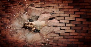 Image of fist through brick